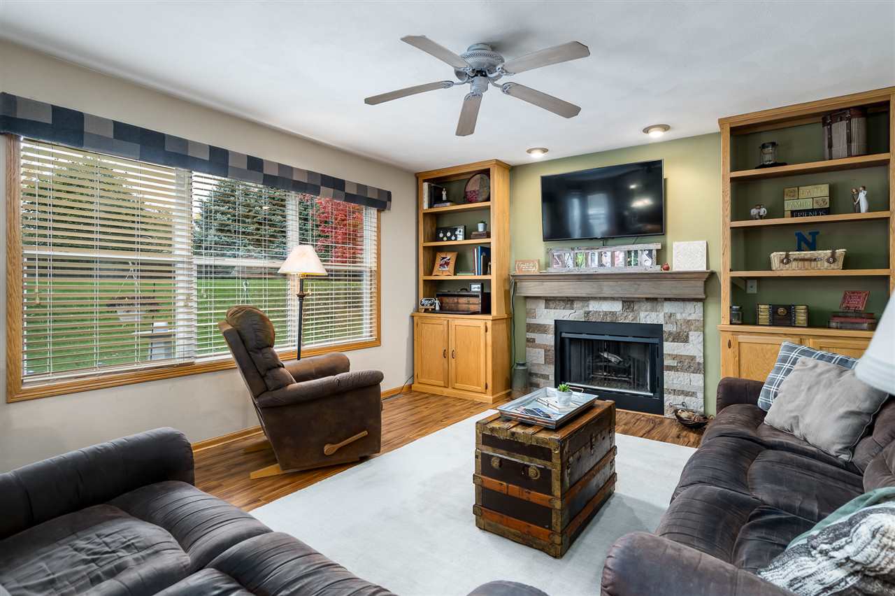 9414 Rambouillet Ridge Roscoe, IL 61073 - Photo 24 of 39 a living room with furniture flat screen tv and a fireplace