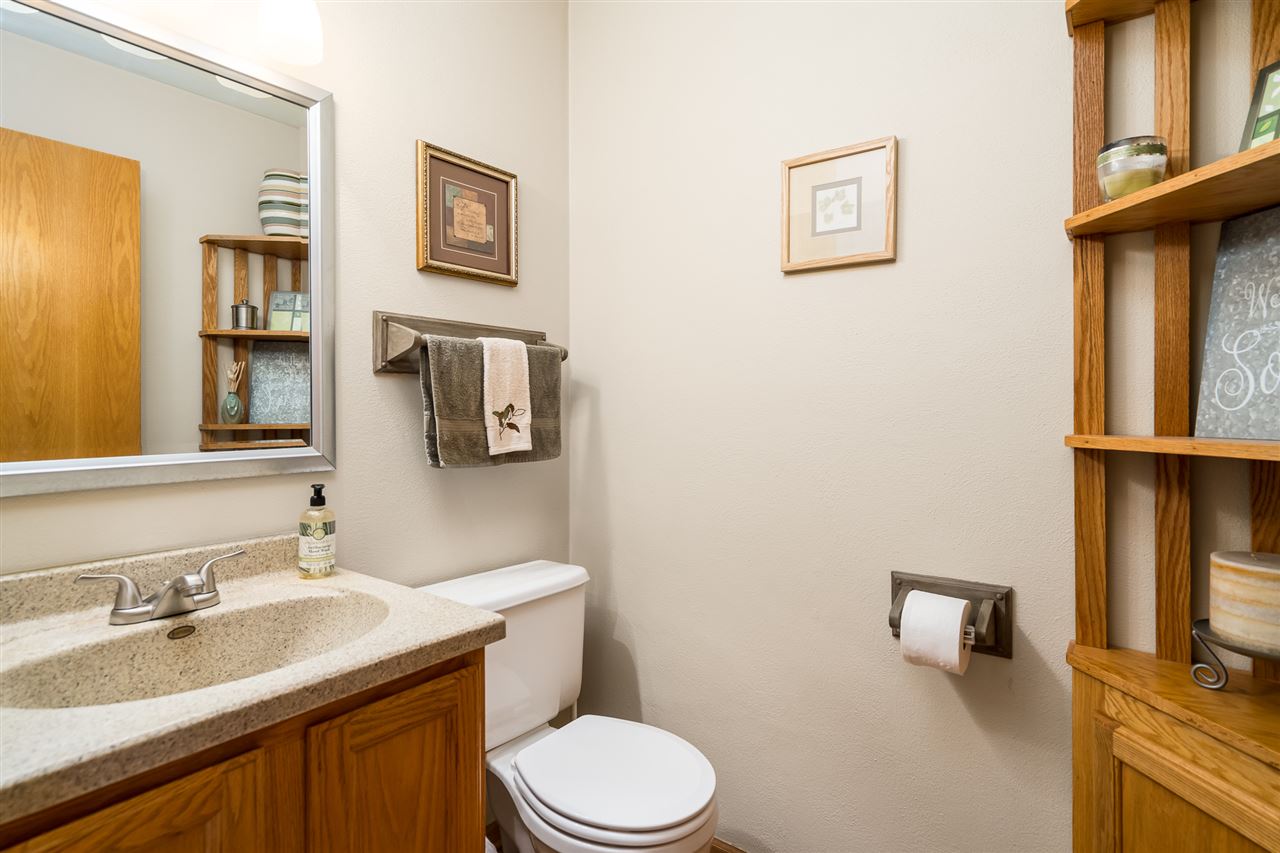 9414 Rambouillet Ridge Roscoe, IL 61073 - Photo 28 of 39 a bathroom with a granite countertop toilet sink and mirror