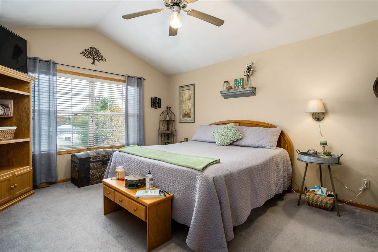 9414 Rambouillet Ridge Roscoe, IL 61073 - Photo 29 of 39 a bedroom with a bed and a chandelier