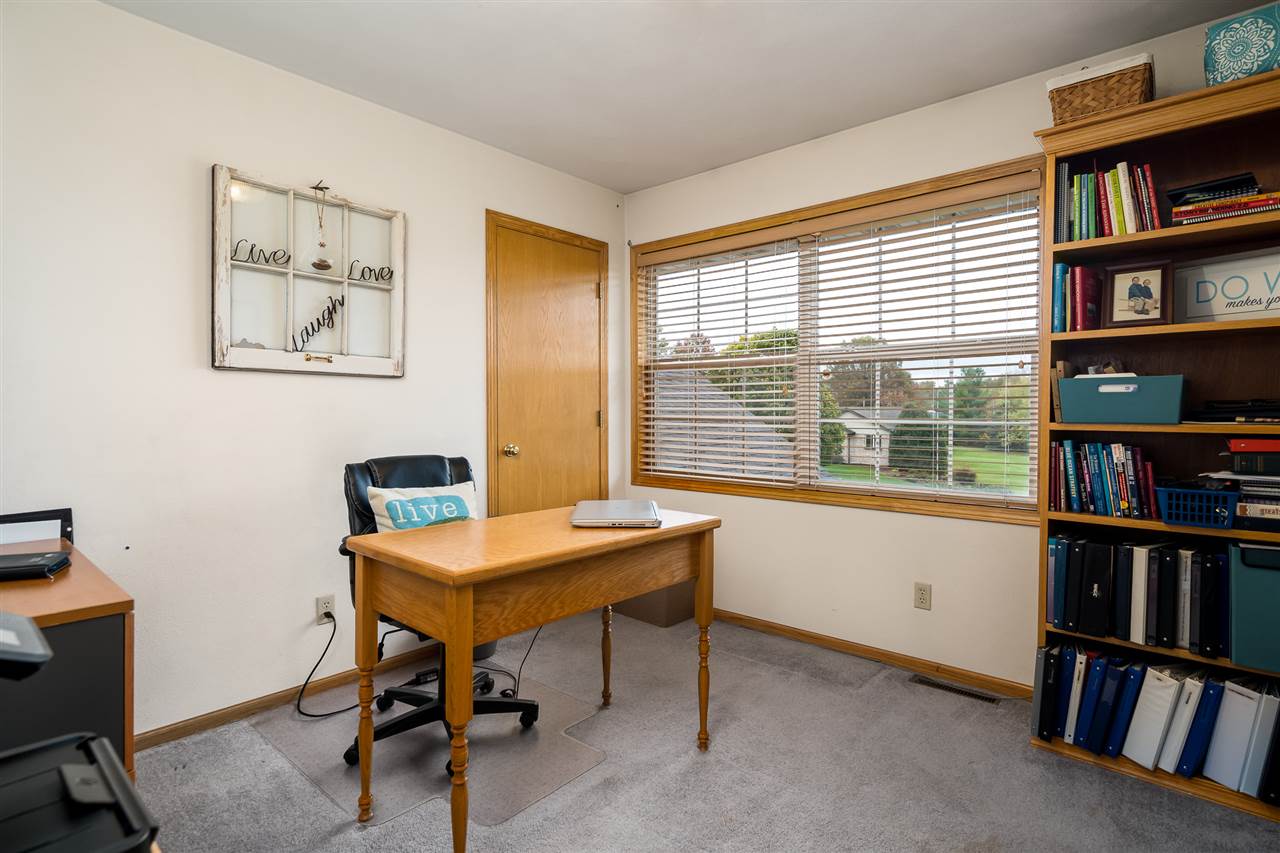 9414 Rambouillet Ridge Roscoe, IL 61073 - Photo 34 of 39 a view of a workspace with furniture and a bookshelf