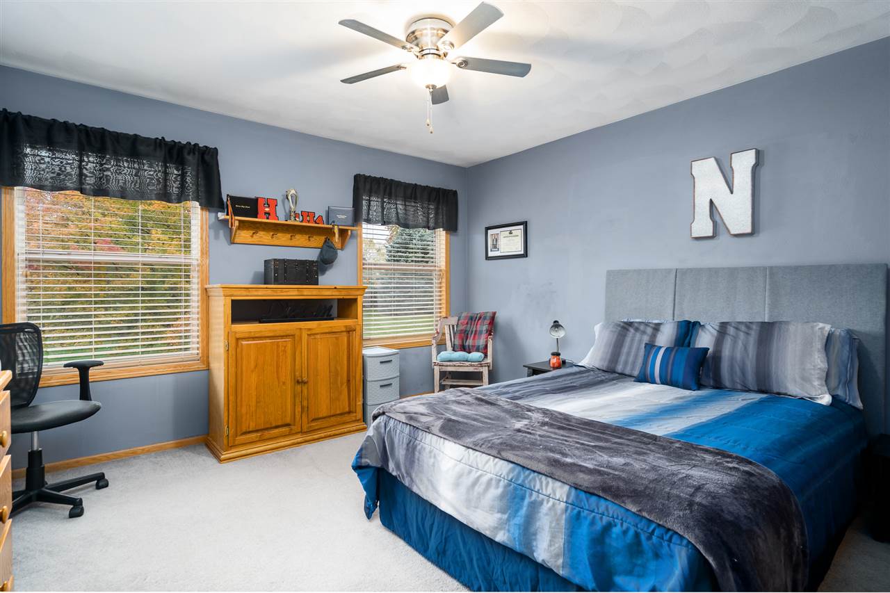 9414 Rambouillet Ridge Roscoe, IL 61073 - Photo 37 of 39 a bedroom with a bed and a chandelier