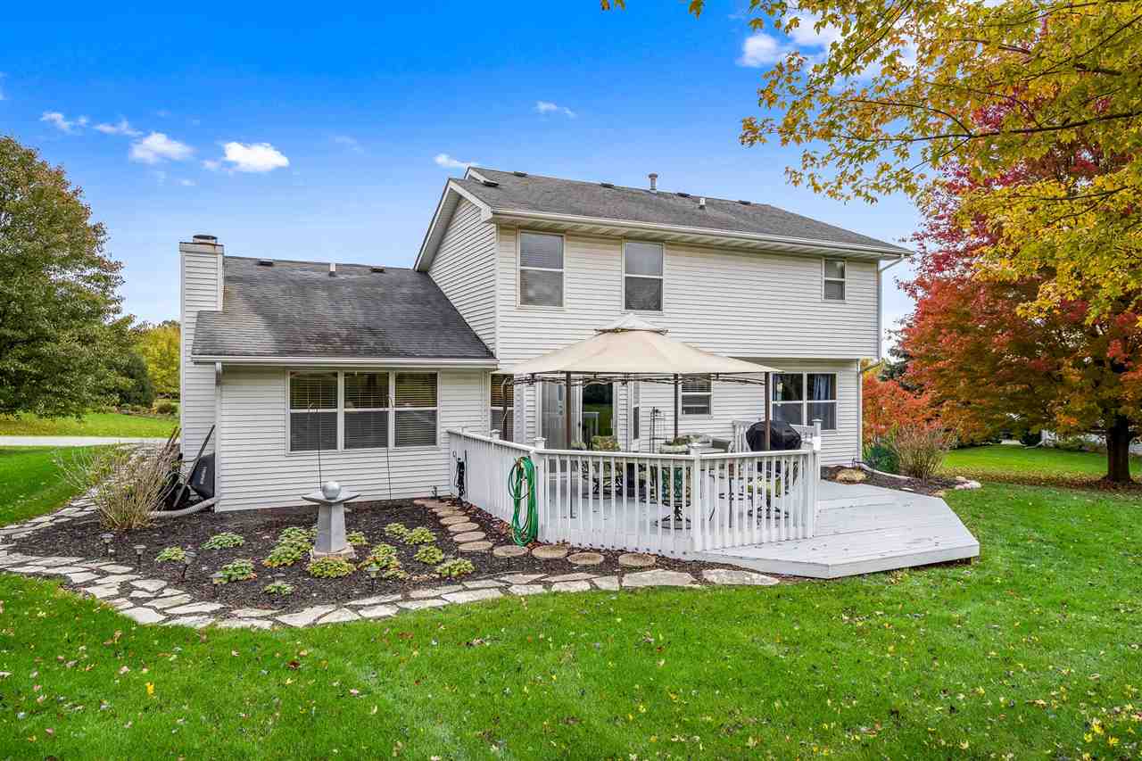 9414 Rambouillet Ridge Roscoe, IL 61073 - Photo 8 of 39 a front view of a house with a yard table and chairs