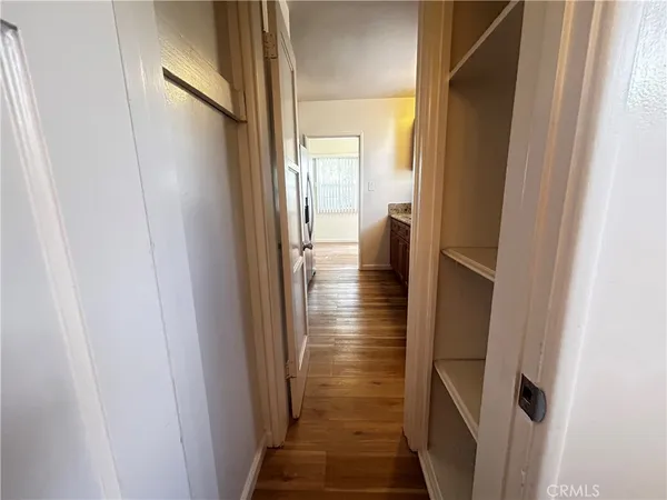 a view of hallway with wooden floor