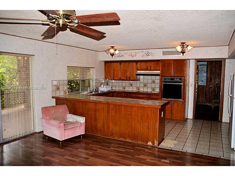 6440 Southwest 69th Avenue Miami, FL 33143 - Photo 11 of 20 a living room with stainless steel appliances kitchen island granite countertop furniture and a fireplace