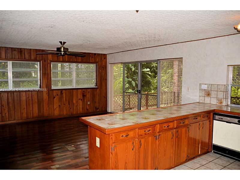 6440 Southwest 69th Avenue Miami, FL 33143 - Photo 10 of 20 a view of a kitchen with a sink and wooden cabinets