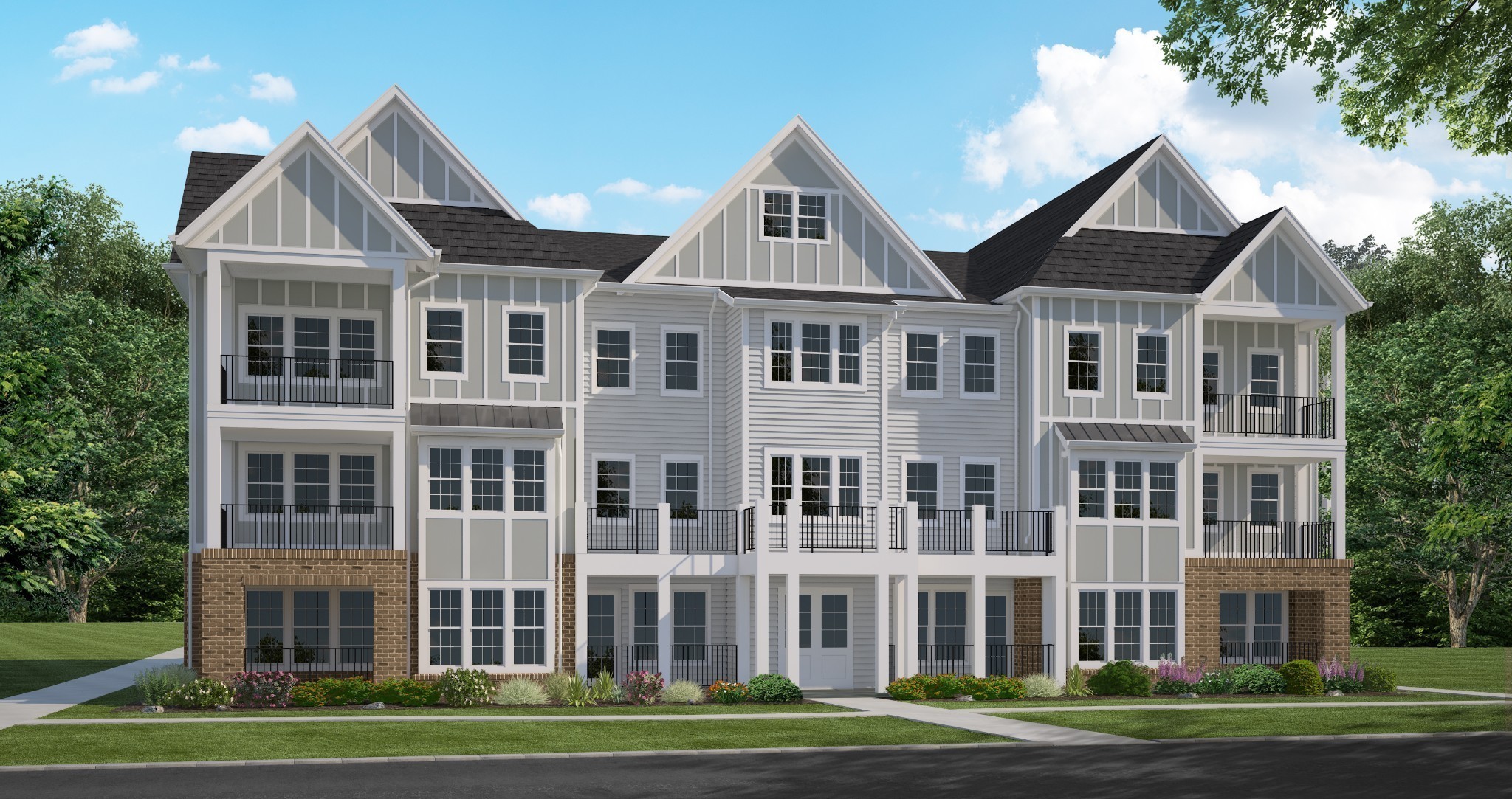 a front view of a residential apartment building with a yard