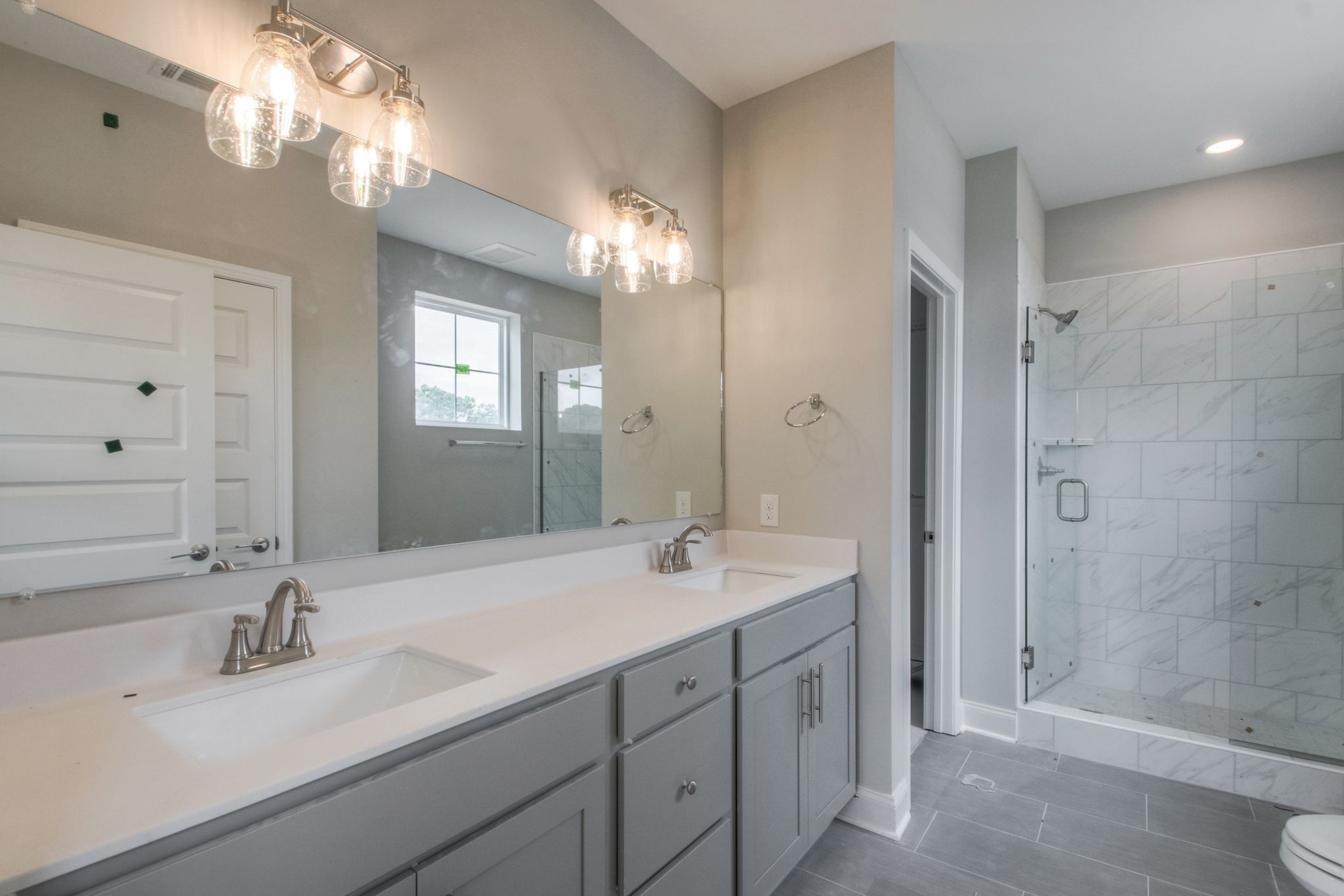 4000 Shadow Green Drive, Unit 4305 Franklin, TN 37064 - Photo 14 of 24 a bathroom with double vanity sinks and a mirror