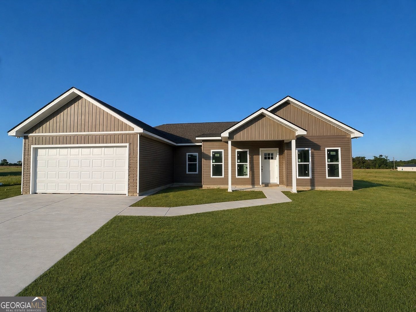 1247 Mark Wood Road Dexter, GA 31019 - Photo 2 of 5 a front view of a house with a yard and garage