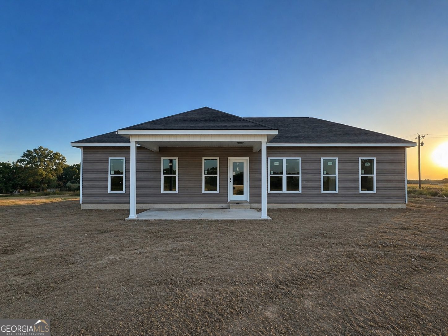1247 Mark Wood Road Dexter, GA 31019 - Photo 5 of 5 a front view of a house with a garden