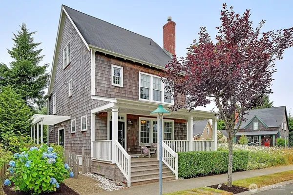 a front view of a house with a yard garage and outdoor seating