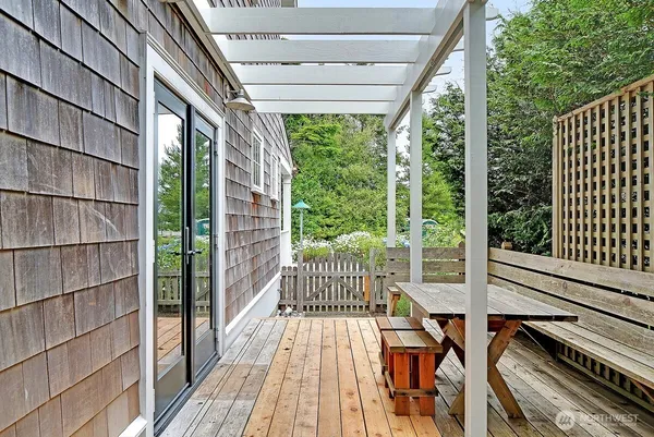a view of balcony with wooden floor and fence