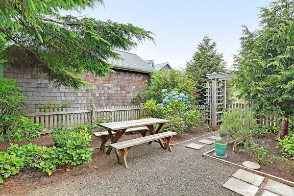 a garden with a bench and some trees