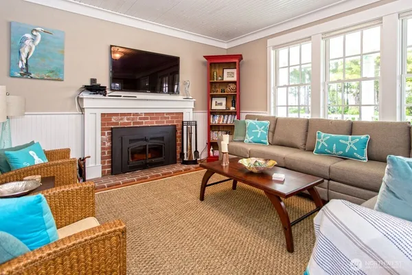 a living room with furniture a flat screen tv and a fireplace