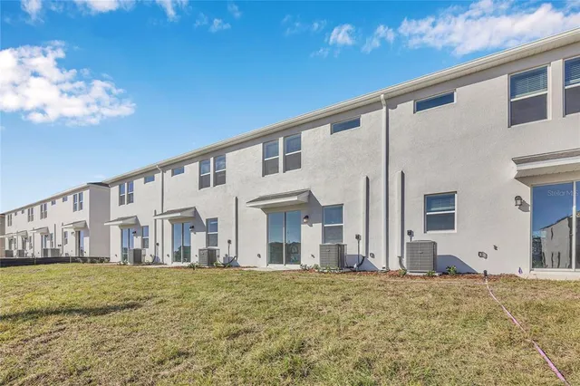 a view of a house with backyard and swimming pool