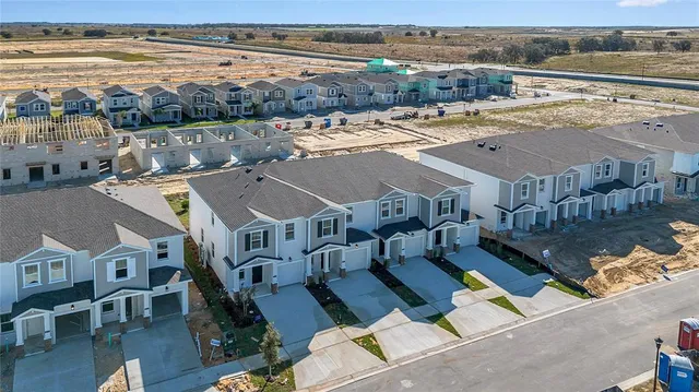 a front view of residential houses with yard