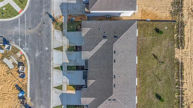 a view of a big house with a big yard and large trees