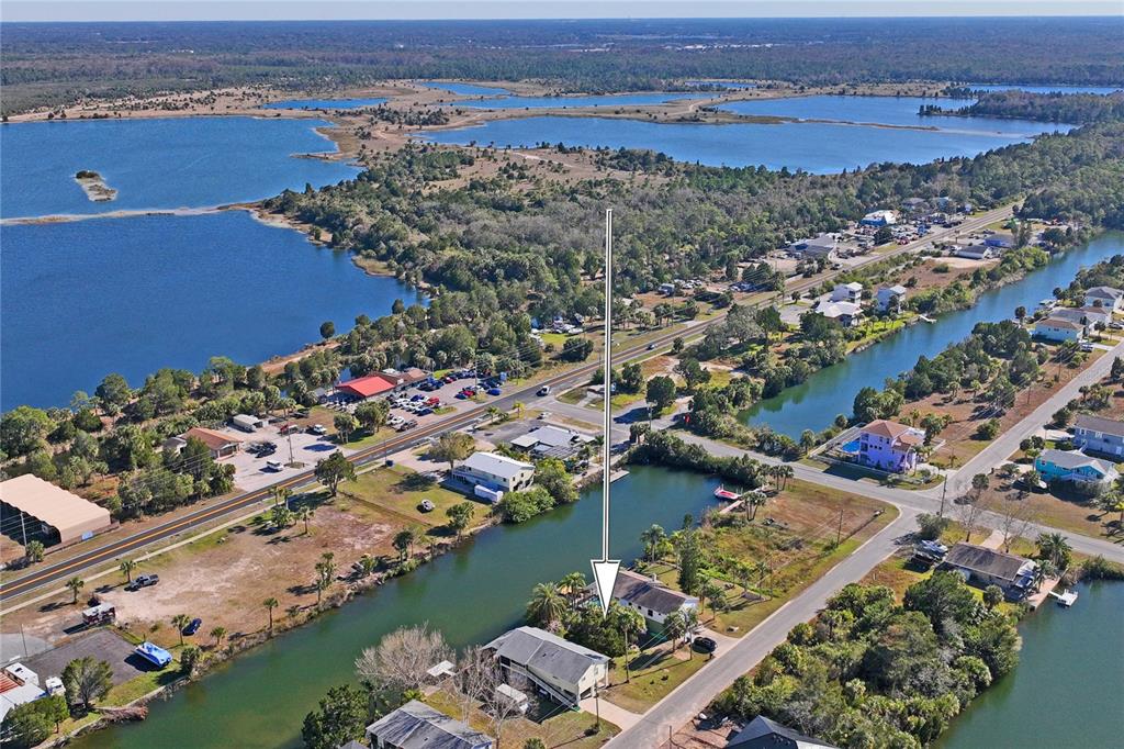 an aerial view of lake and residential houses with outdoor space
