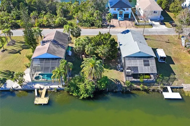 an aerial view of a house with swimming pool outdoor seating and yard