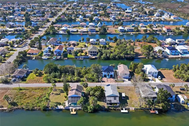 an outdoor space with lots of trees houses and lake view