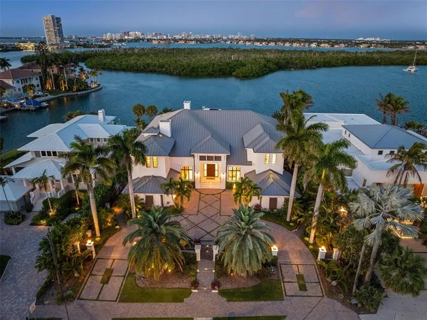 an aerial view of a house with outdoor space and lake view