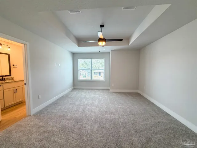 an empty room with a window and a fireplace