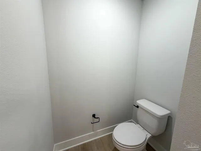 a white toilet sitting next to a shower