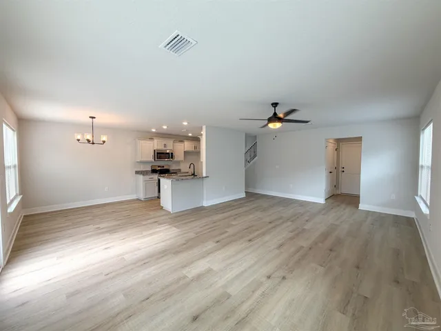 a view of a kitchen with wooden floor and a kitchen