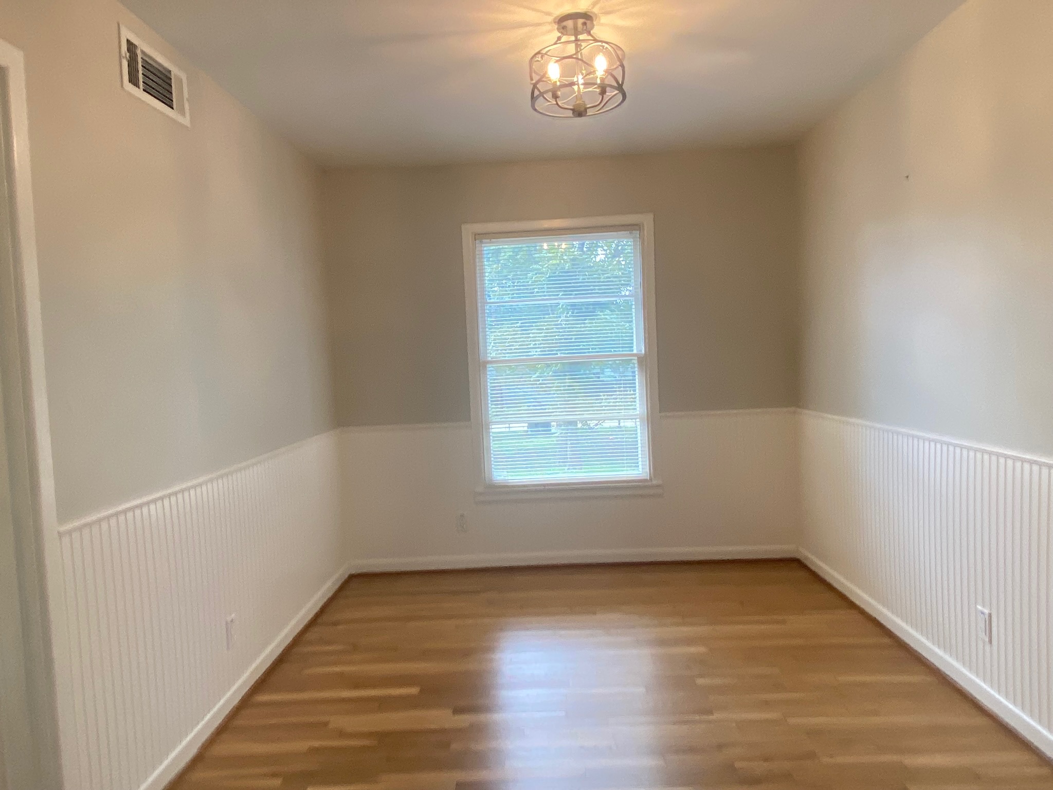 1818 South 39th Street Temple, TX 76504 - Photo 6 of 15 an empty room with wooden floor and windows