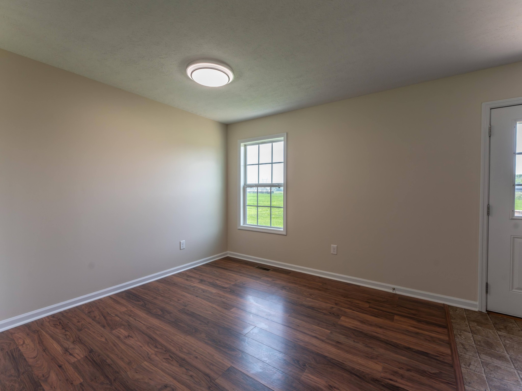 4214 Thick Road Chapel Hill, TN 37034 - Photo 11 of 29 a view of an empty room with wooden floor and a window