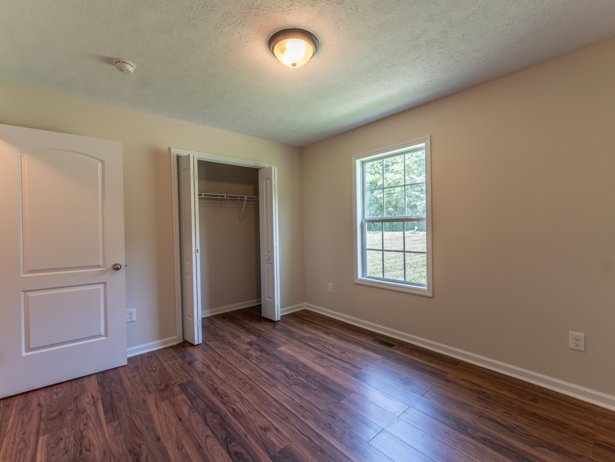 4214 Thick Road Chapel Hill, TN 37034 - Photo 23 of 29 an empty room with wooden floor and windows
