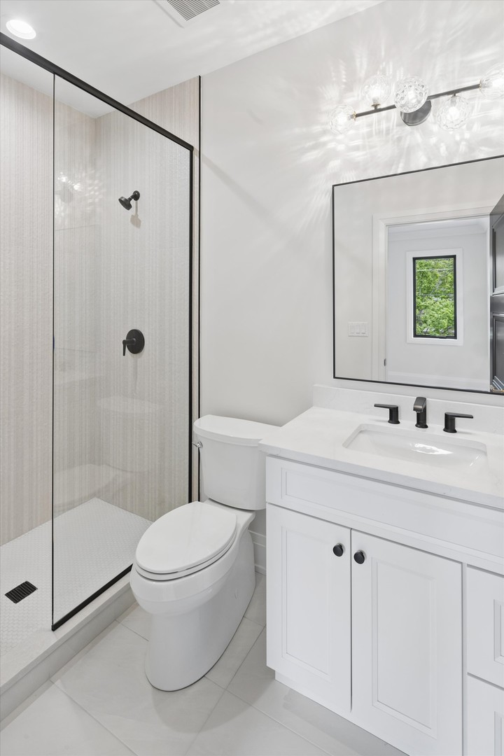 196 Walnut Street Elmhurst, IL 60126 - Photo 17 of 37 a bathroom with a sink a toilet and shower