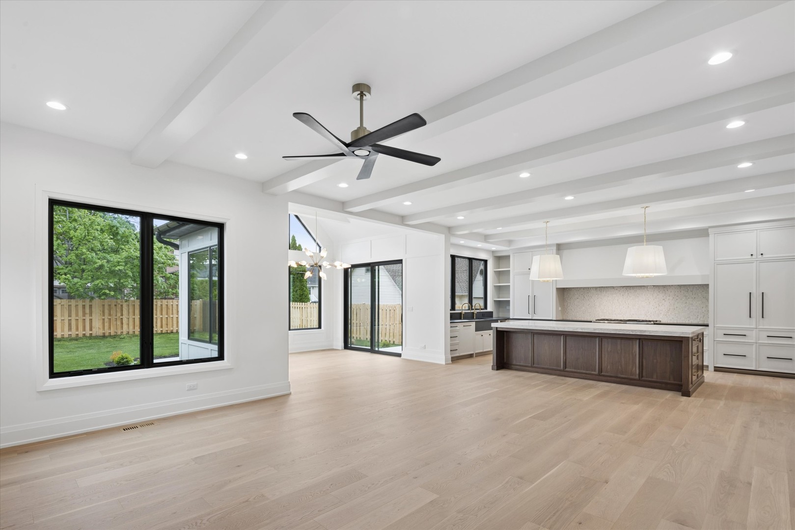 196 Walnut Street Elmhurst, IL 60126 - Photo 6 of 37 a view of a big room with windows and chandelier fan