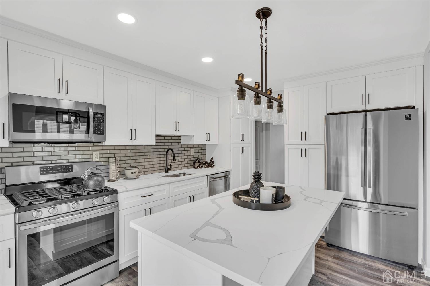 45 Harmon Road Edison, NJ 08837 - Photo 11 of 44 a kitchen with refrigerator a stove and cabinets
