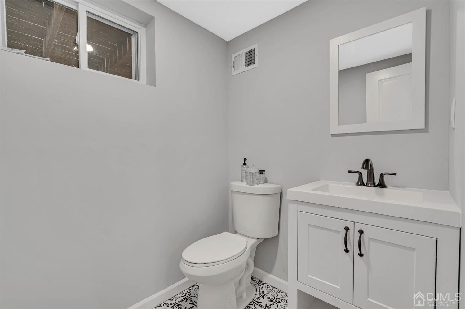 45 Harmon Road Edison, NJ 08837 - Photo 35 of 44 a bathroom with a sink toilet and vanity