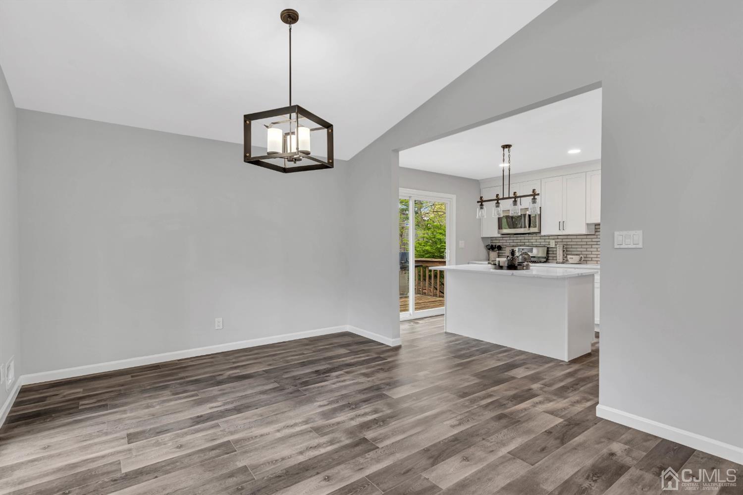 45 Harmon Road Edison, NJ 08837 - Photo 10 of 44 a view of a kitchen with wooden floor and a ceiling fan
