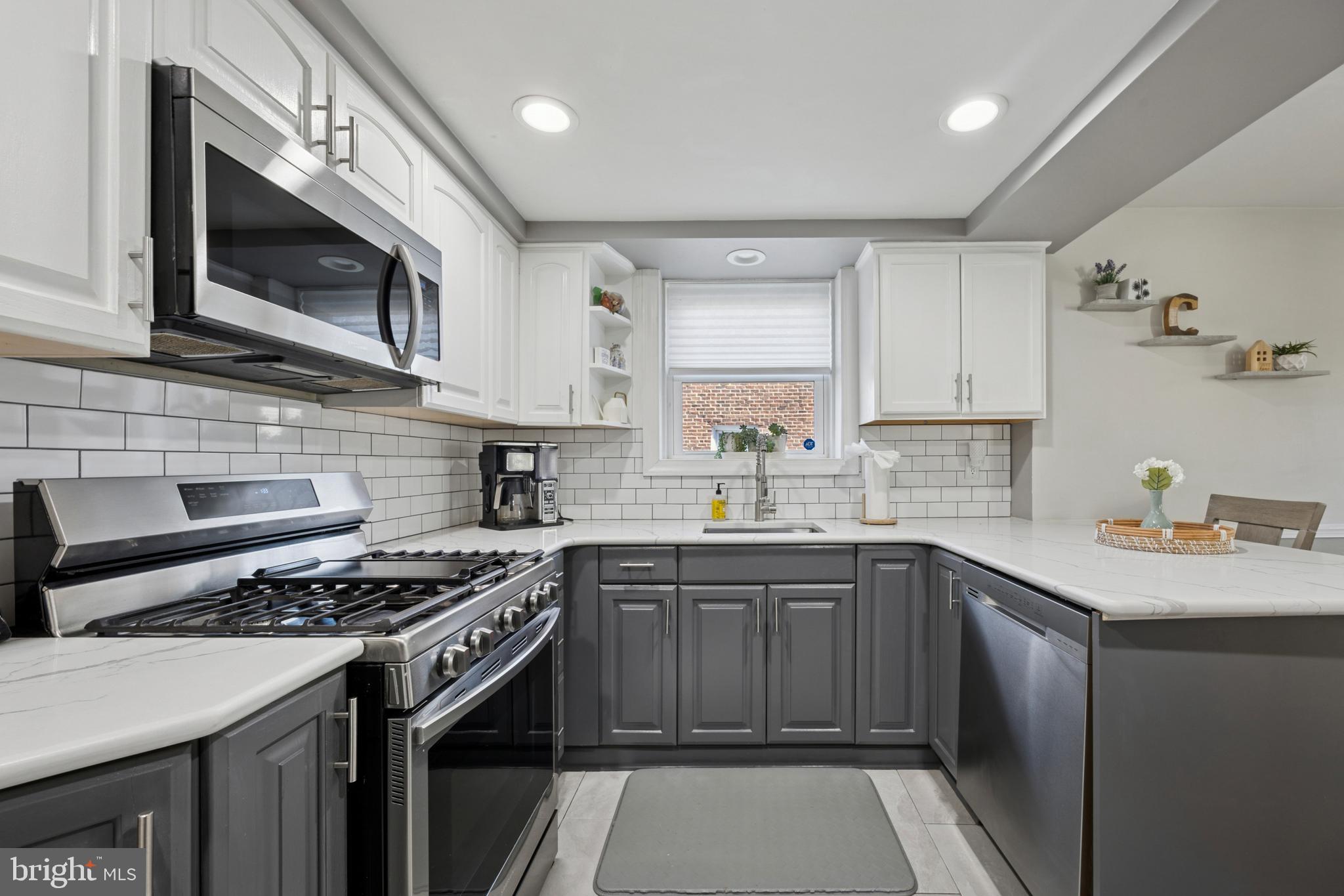 487 East Springfield Road Springfield, PA 19064 - Photo 9 of 29 a kitchen with stainless steel appliances a sink stove and microwave