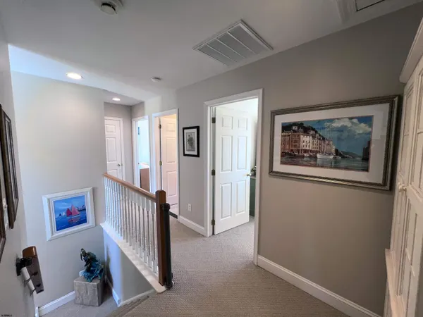 a view of a hallway with windows and entryway