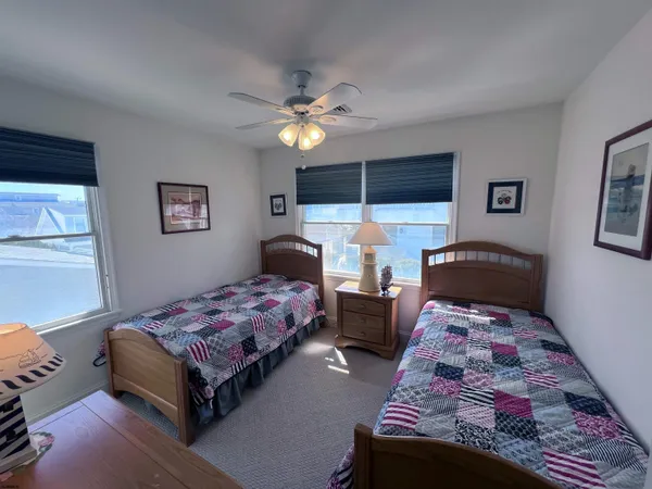 a bedroom with two beds and a chandelier