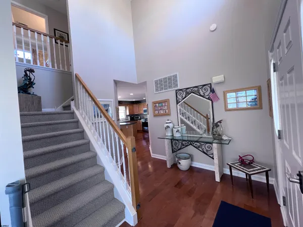a view of entryway and workspace with wooden floor