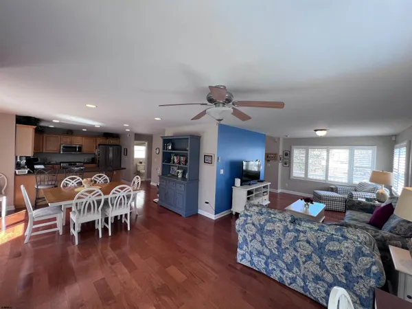 a living room with furniture dining table and a large window