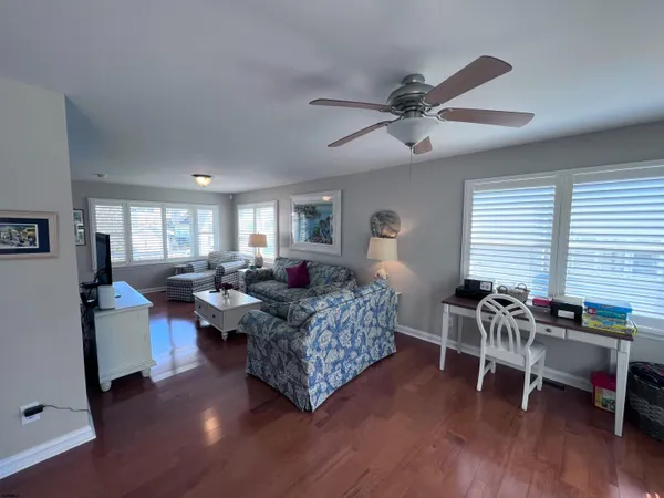 a living room with furniture a wooden floor and a window