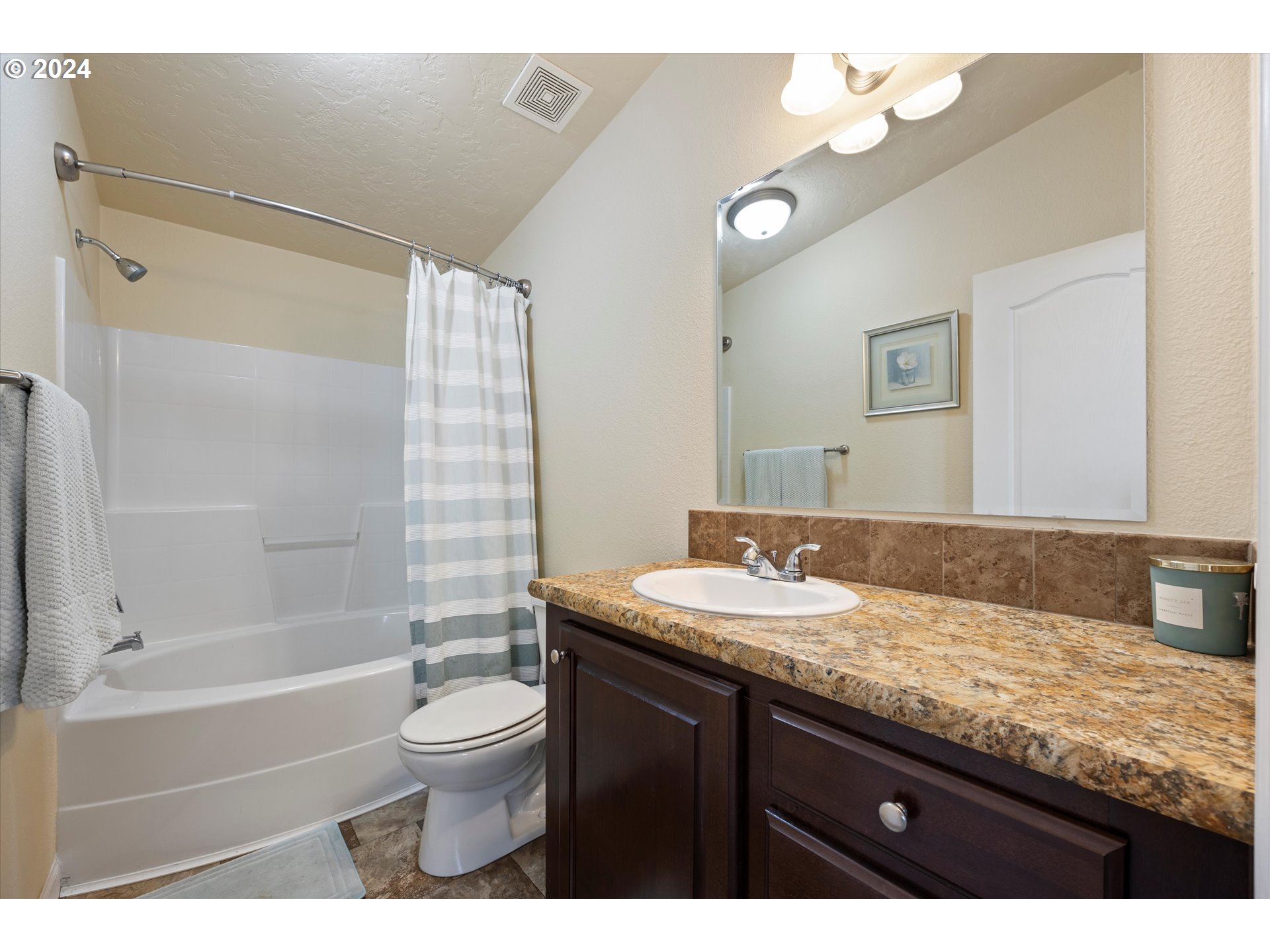 3076 Southwest River View Drive Pendleton, OR 97801 - Photo 11 of 37 a bathroom with a granite countertop sink toilet a large mirror a bathtub and shower