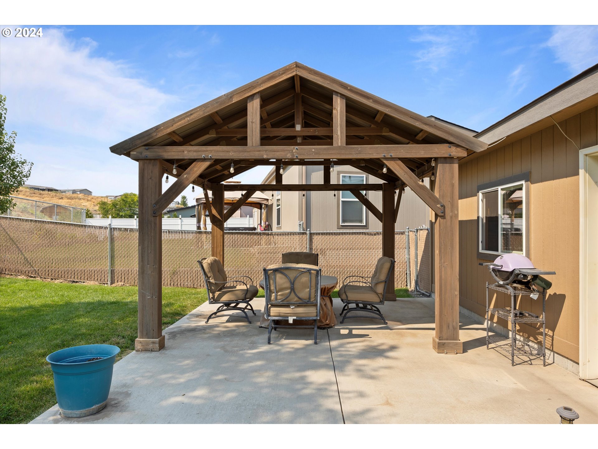 3076 Southwest River View Drive Pendleton, OR 97801 - Photo 34 of 37 a front view of a patio with table and chairs and potted plants