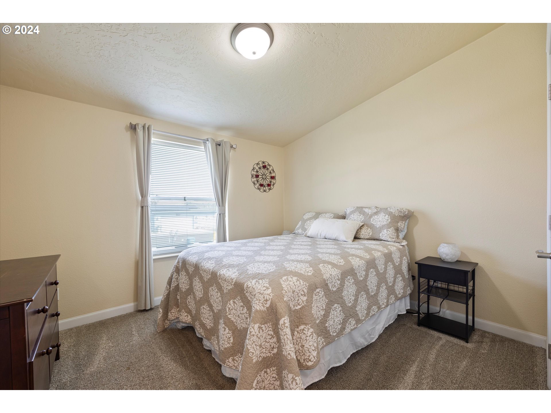 3076 Southwest River View Drive Pendleton, OR 97801 - Photo 7 of 37 a bedroom with a bed table chair and a window