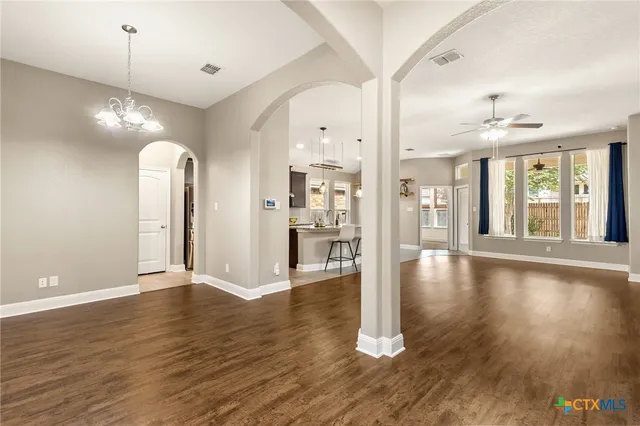 a view of an empty room and wooden floor