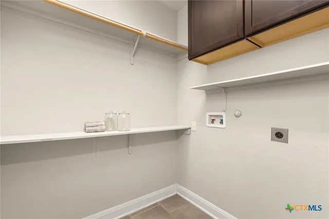 a view of storage and utility room with racks on the wall