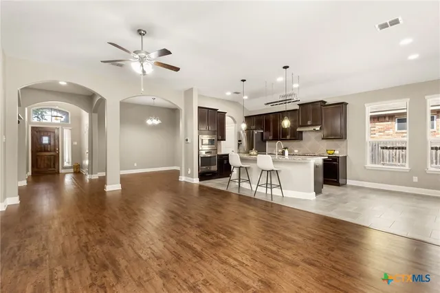 a view of a kitchen with furniture and wooden floor
