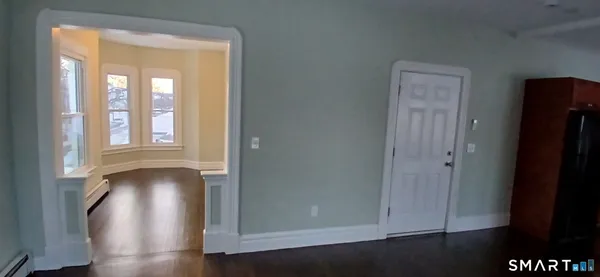 a view of an entryway with wooden floor