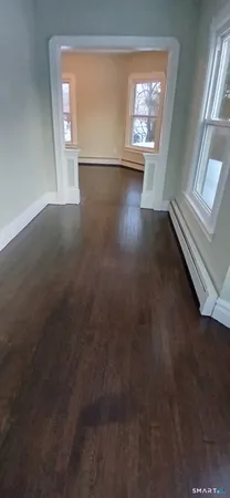 an empty room with windows and closet