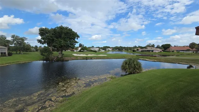 a view of a lake with houses in the background